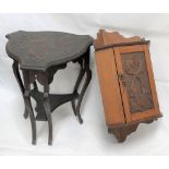 A small Arts & Crafts oak wall hanging corner cabinet, the door carved with two entwined fish and