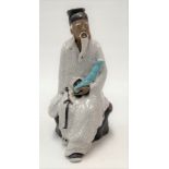 A Chinese earthenware figure incense holder modelled as a seated elderly sage, height 18cm