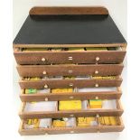 An oak Meccano part storage cabinet with six drawers containing boxed Meccano spares, width of box
