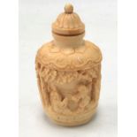 A 19th century Chinese carved ivory snuff bottle, carved and pierced with figures in a trellis