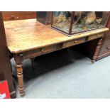 A 19th Century fruitwood farmhouse table with three frieze drawers and on ring turned tapering legs,