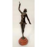 An Art Deco style bronze model of a female dancer upon red marble stepped base, height 39cm.