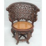 A good eastern Dutch colonial Burgomeister carved and pierced hardwood chair with cane seat, the top