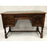 Oak replica writing desk with green leather gilt tooled writing inset over a kneehole recess with
