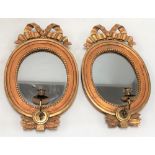 Pair of small oval giltwood and gesso Girondelle oval wall mirrors with ribbon surmounts, height