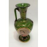 A 19th century Bohemian green glass pedestal vase, the front with oval white opaque portrait panel