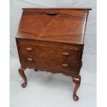 A 1930s rosewood bureau, the fall front with carved handle revealing a fitted interior with pigeon