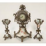 A brass and pottery cased timepiece garniture, the timepiece with 1.75in dial, height 29cm.