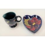 Moorcroft cream jug, tube line decorated with flowers on a dark blue ground, impressed marks to