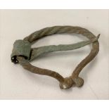 Viking bronze penannular brooch of twisted form and with blunt terminals and with pin, width 5cm.