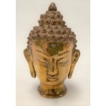 A brass Buddha head, height 11cm