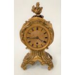 A French ormolu timepiece with 3.5in gilt dial with black Roman Numerals and within a foliate scroll