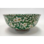 20th Century Chinese prunus blossom decorated bowl with green ground, four character seal mark to
