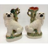 A pair of Victorian Staffordshire Pottery opposing spaniel spill vases (both af), height 33cm.
