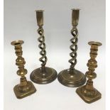 A pair of brass of open twist candlesticks, height 30cm, together with another pair of brass