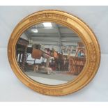 A gilt gesso framed oval wall mirror, 70 x 79cm.