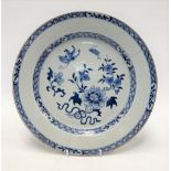 An 18th Century Chinese export large blue and white underglaze dish, the well decorated with