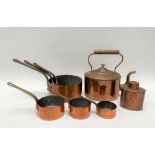 A copper and brass set of six graduated saucepans, the largest width including handle 32cm, together