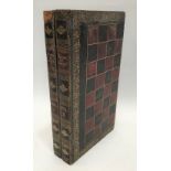 A Victorian Moroccan gilt tooled leather games box in the form of two books, hinged to reveal a