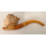 A Meerschaum pipe, the bowl carved as a ladies head and with amber mouth piece within a fitted