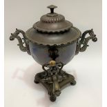 A 19th century copper tea urn with twin foliate cast scroll handles, height 32cm.