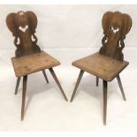 A pair of 19th Century continental fruitwood hall chairs with pierced shaped backs over moulded