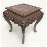 20th Century Chinese red lacquer square section stand or table, the top painted with a blossoming