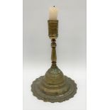 An early brass ship's candlestick upon large circular base, height 29cm.