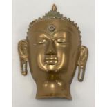 A brass Buddha wall mask, height 19cm
