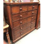 A Victorian mahogany veneered straight-front chest of two short over four long drawers upon a plinth