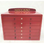 Meccano burgundy painted six drawer chest, the back with cardboard parts diagram, width 55cm.