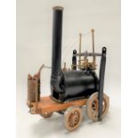 A model steam engine in the form of Richard Trevithick's locomotive, height 28cm.