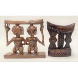 Two African head rests, one carved with two figures, in Louba style, width 19cm.