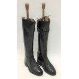 A pair of black leather riding boots with boot trees, length of sole 10'.