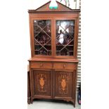 A Sheraton Revival mahogany inlaid bookcase, the broken arched top over a pair of astragal glazed