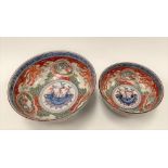 A pair of Japanese graduated porcelain underglaze blue and enamel painted bowls, for the European