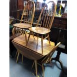 An Ercol pale elm drop-leaf circular table with set of six hoop and stick back chairs, diameter of