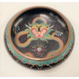 A Chinese cloisonné shallow bowl decorated with dragons chasing the flaming pearl on a black ground,