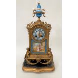A gilt spelter cased two-train mantel clock with porcelain dial panel and finial, the 3in dial