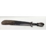 A tribal Trobriand Islands Massim war club of paddle form with incised decorations, length 83cm.