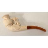 A Meerschaum cheroot pipe with amber mouth piece, carved as a dog upon a saddle, within original