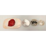 Three mother of pearl buttons; together with a wax seal (4).