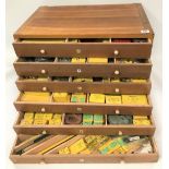 An oak Meccano six drawer chest containing boxed Meccano parts and spares, width 60cm