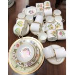 A modern Royal Worcester porcelain set of twenty coffee cans and saucers, with botanical decoration,