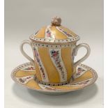 A 19th century Sevres lidded chocolate pot with twin handles and on saucer dish, painted with floral