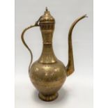 A Turkish brass lidded coffee pot with embossed decoration and with inscriptions, height 43cm