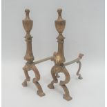 A pair of brass fire dogs with urn finials, height 31cm