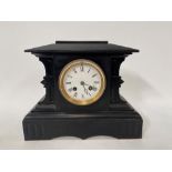 A black slate two-train mantel clock with 3.5in dial, the French movement striking on a bell, within