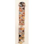 A 19th century rose gold bracelet set with two rows of triangular carved lava mask panels, length