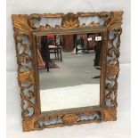 A rectangular giltwood wall mirror, the frame carved and pierced with scallop shells and leaf